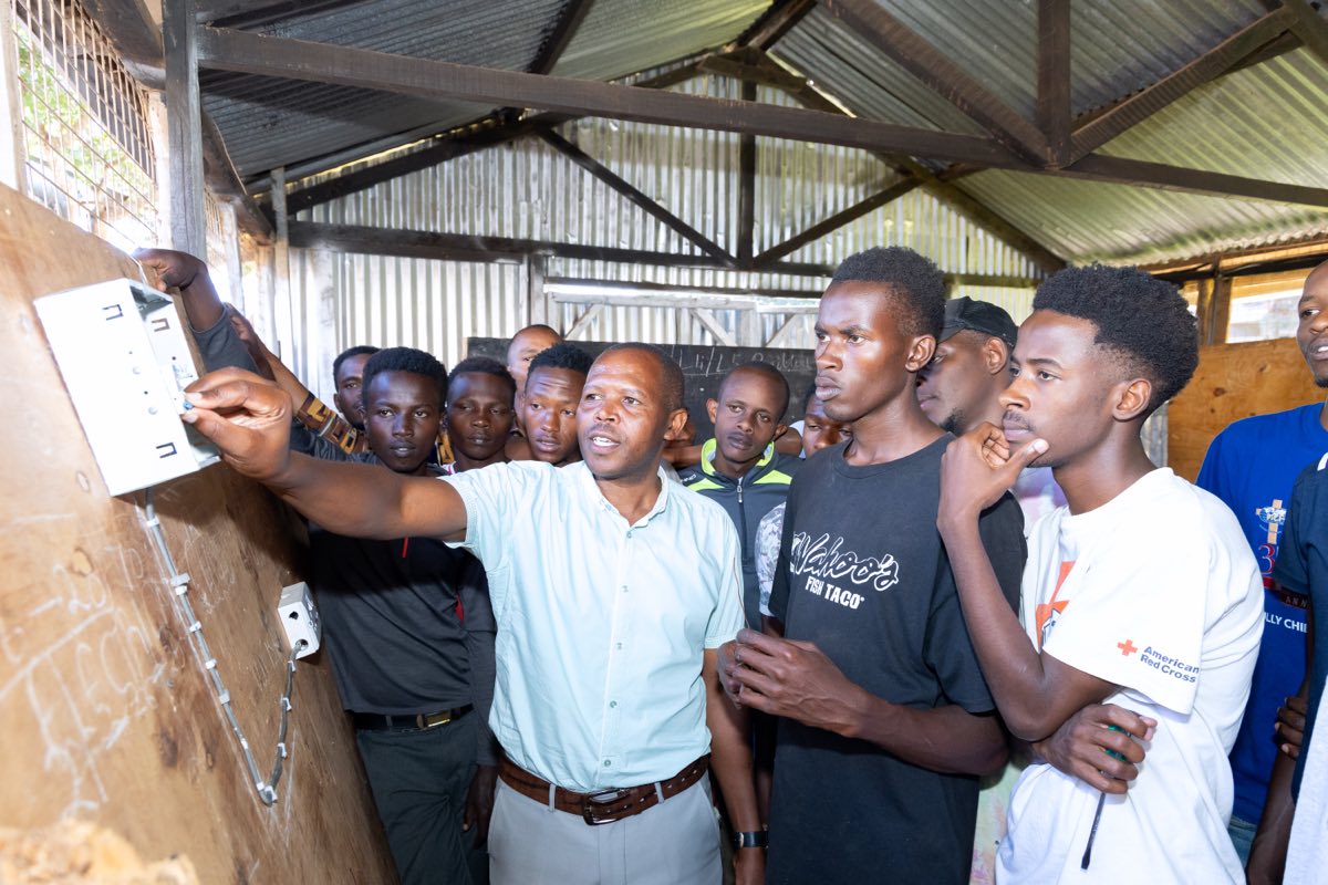 A trainer demonstrating an electrical installation to a group of students