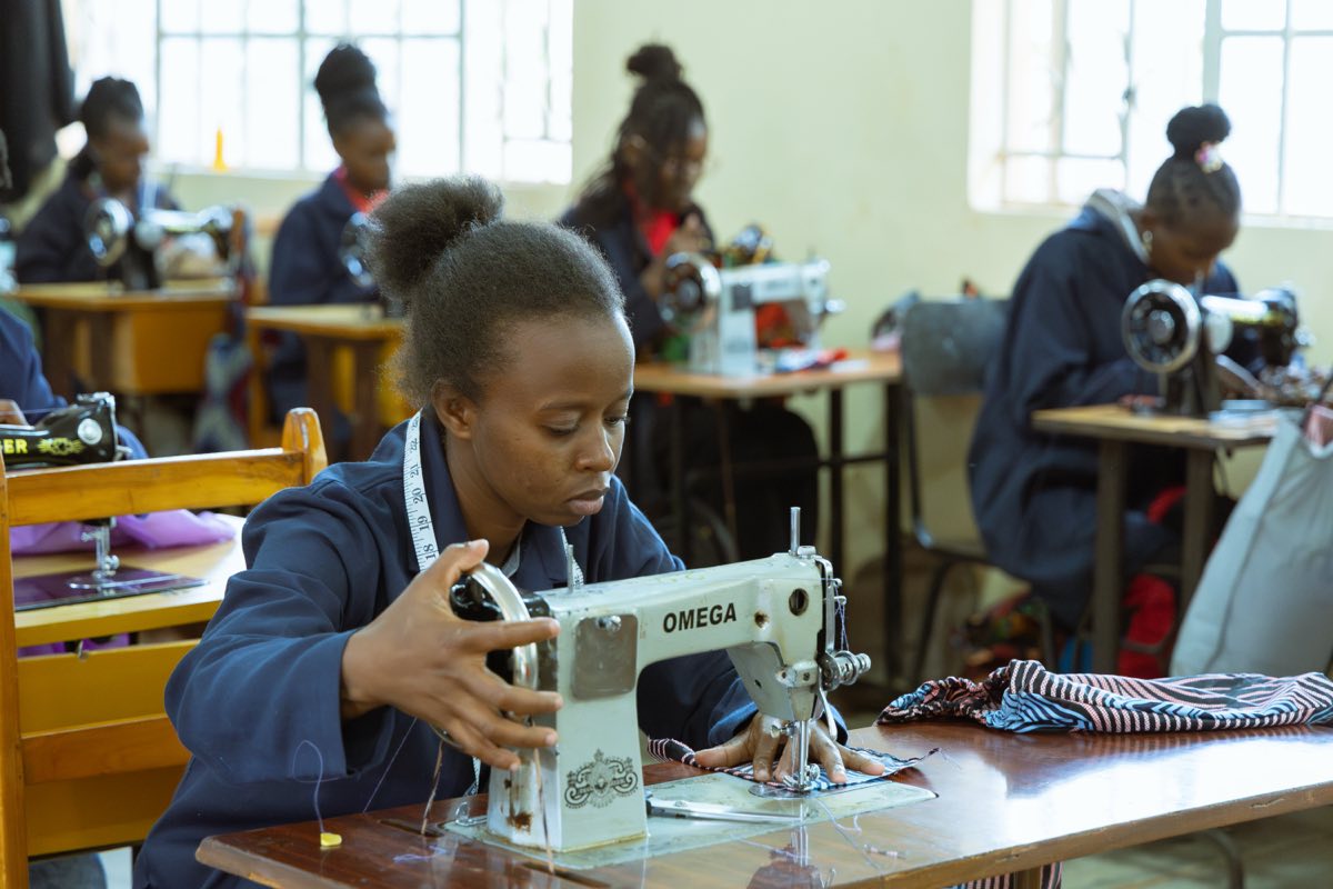 A fashion and design trainee working on a garment
